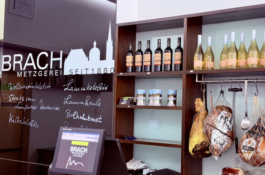 Regal mit Wein- und Schinkenspezialitäten in der Metzgerei Brach am Dom